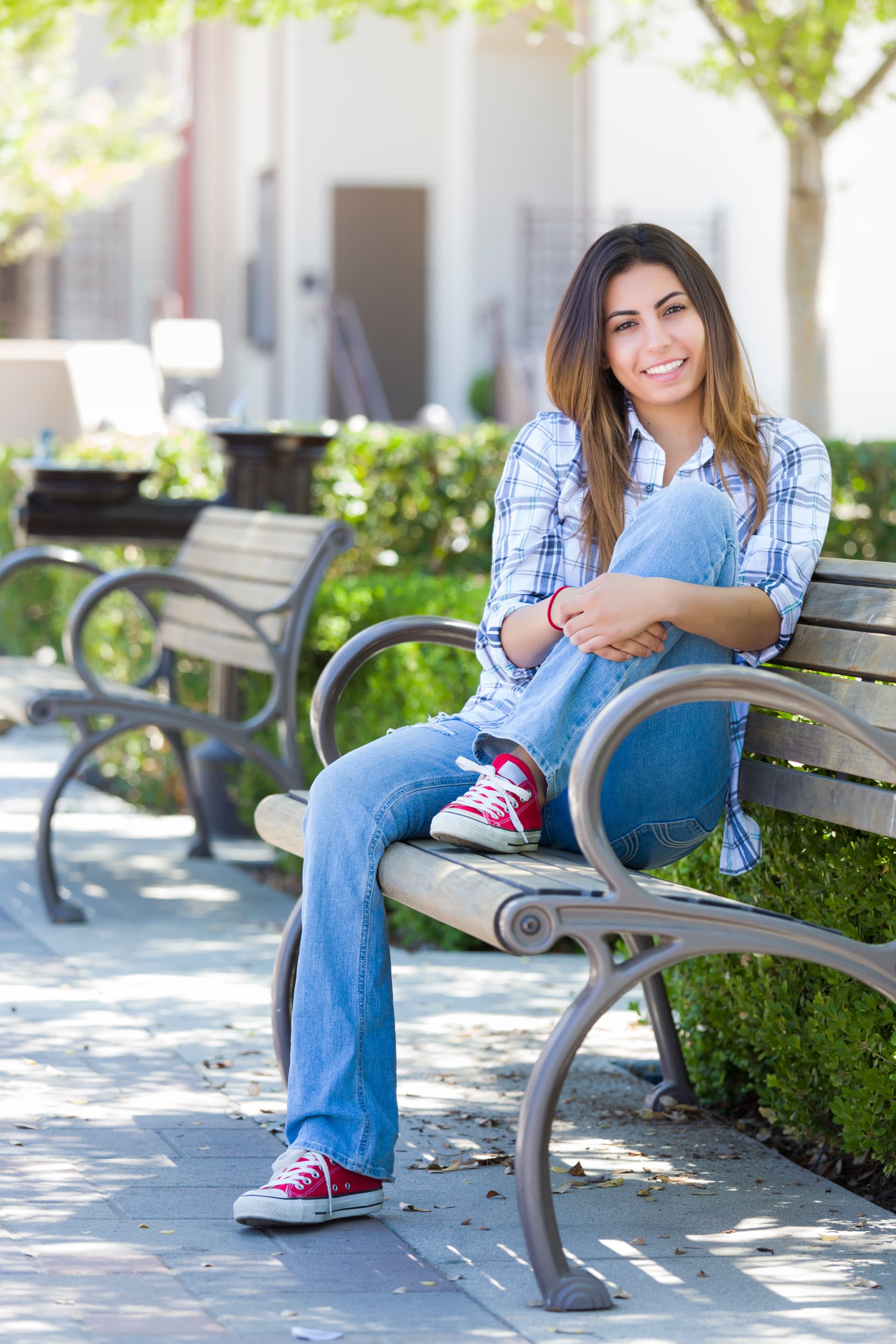 Happy Mixed Race Female Student Portrait on School Campus Bench.