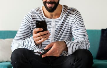 Man using device on couch