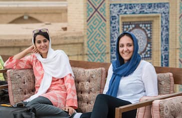 Young women are sitting in a rooftop cafe, Yazd. Iran