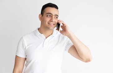 Smiling handsome man talking on smartphone
