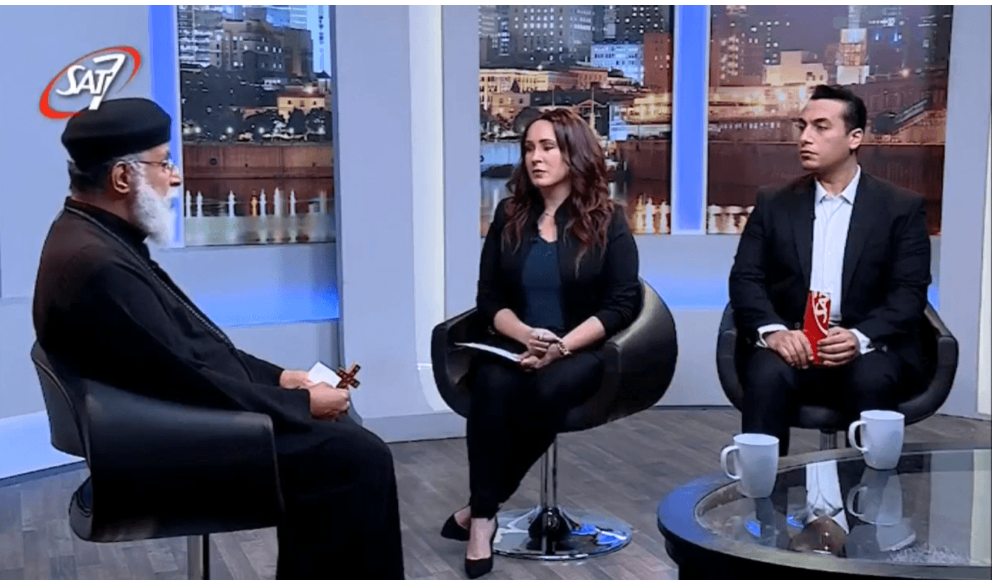 Father Athanasios Maher talks to Nermine Fayak and Mina Makram (right) on In the Midst of Darkness