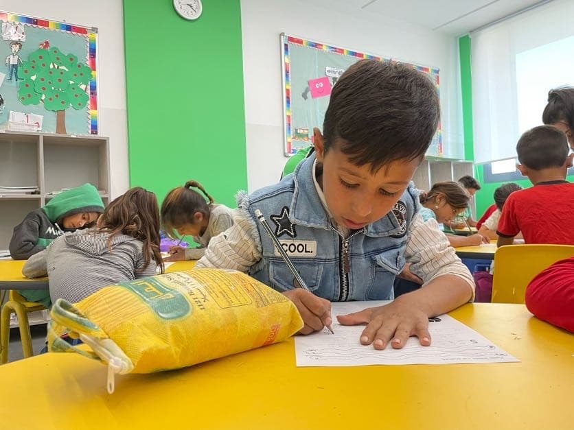 The family of this boy at HOPE school made him a makeshift school bag out of a rice bag